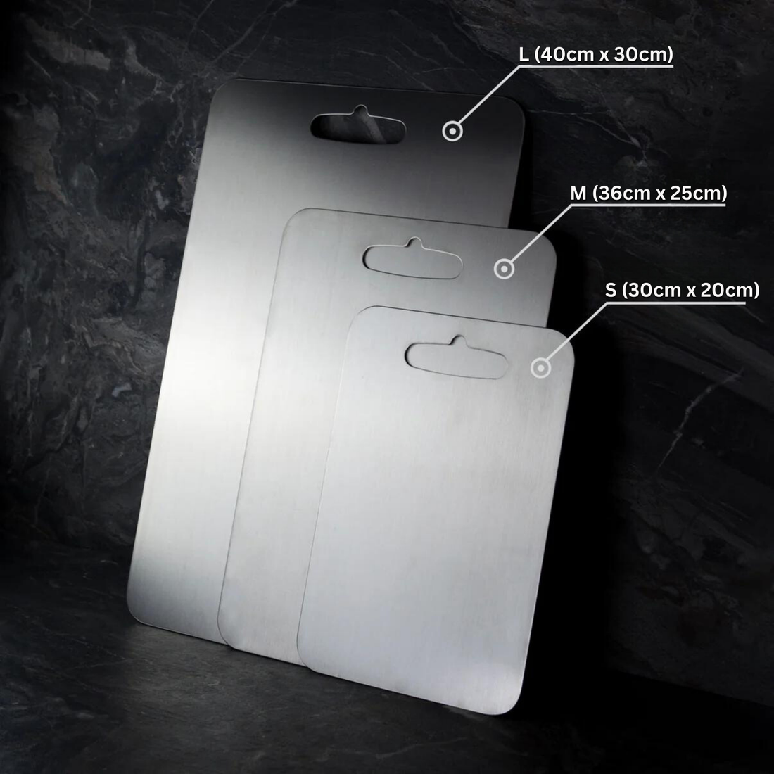 Medical grade titanium cutting board with non-porous silver surface, rounded edges, and ergonomic design for ultimate hygiene
