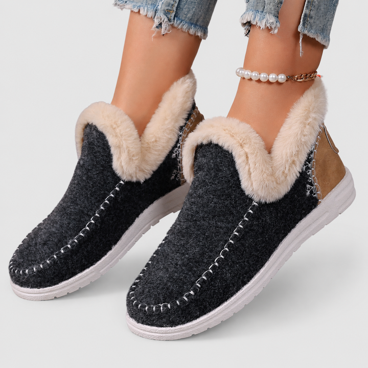 Women's cozy plush indoor slippers, featuring a slip-on design and ergonomic foot support.
