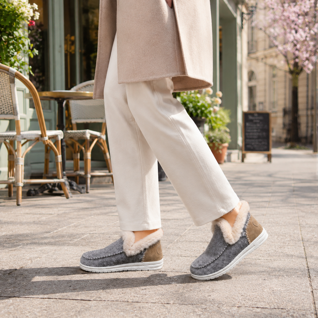 Warm women's house slippers with soft plush lining and arch support for comfort.