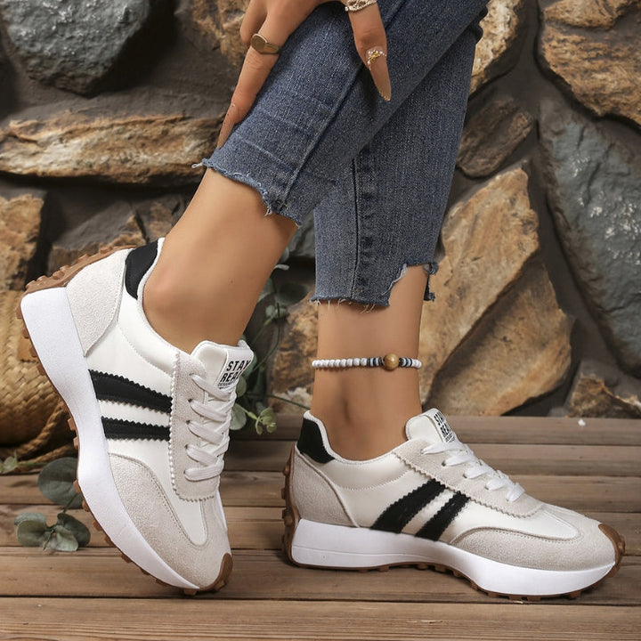 Close-up of women's retro chunky platform sneakers, showing lace-up detail and orthopedic comfort features.