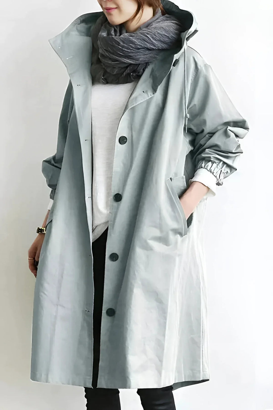 Women's stylish hooded raincoat. Weatherproof trench coat for chic urban fashion.