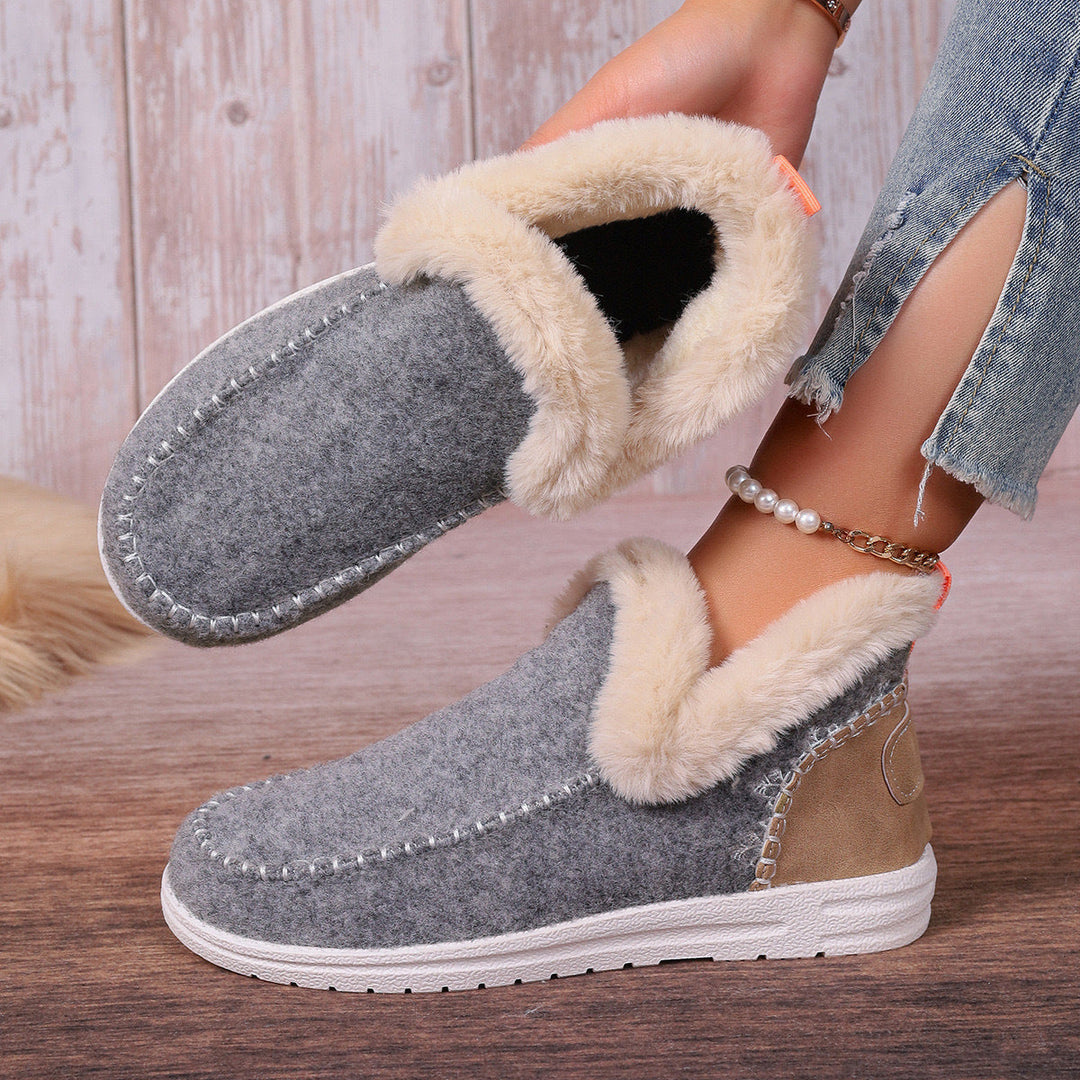 Plush women's comfort slippers, designed as slip-on indoor shoes with foot support.
