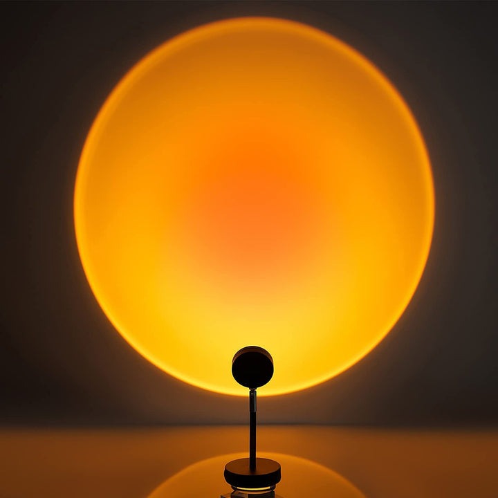 LED USB sunset projector lamp, perfect for bedroom or gaming room ambient lighting. Remote control for easy mood adjustment.