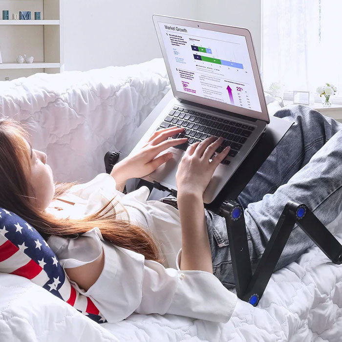 Adjustable ergonomic laptop stand with flexible height and angle. Features venting design, suitable for home or office use.