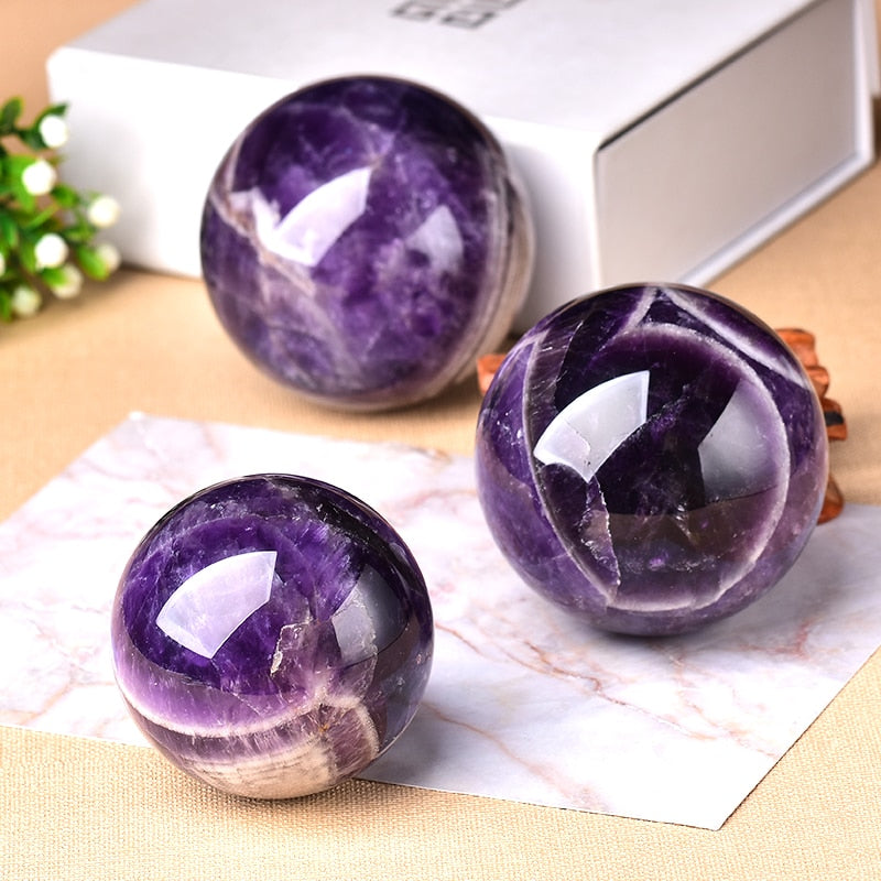 Vibrant amethyst crystal ball, perfect spiritual gift & calming home accent.