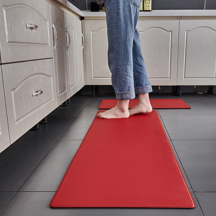 "Anti-slip waterproof kitchen rug with comfort cushioning, durable PVC, two-sided no-slip design, in grey rhombus pattern."