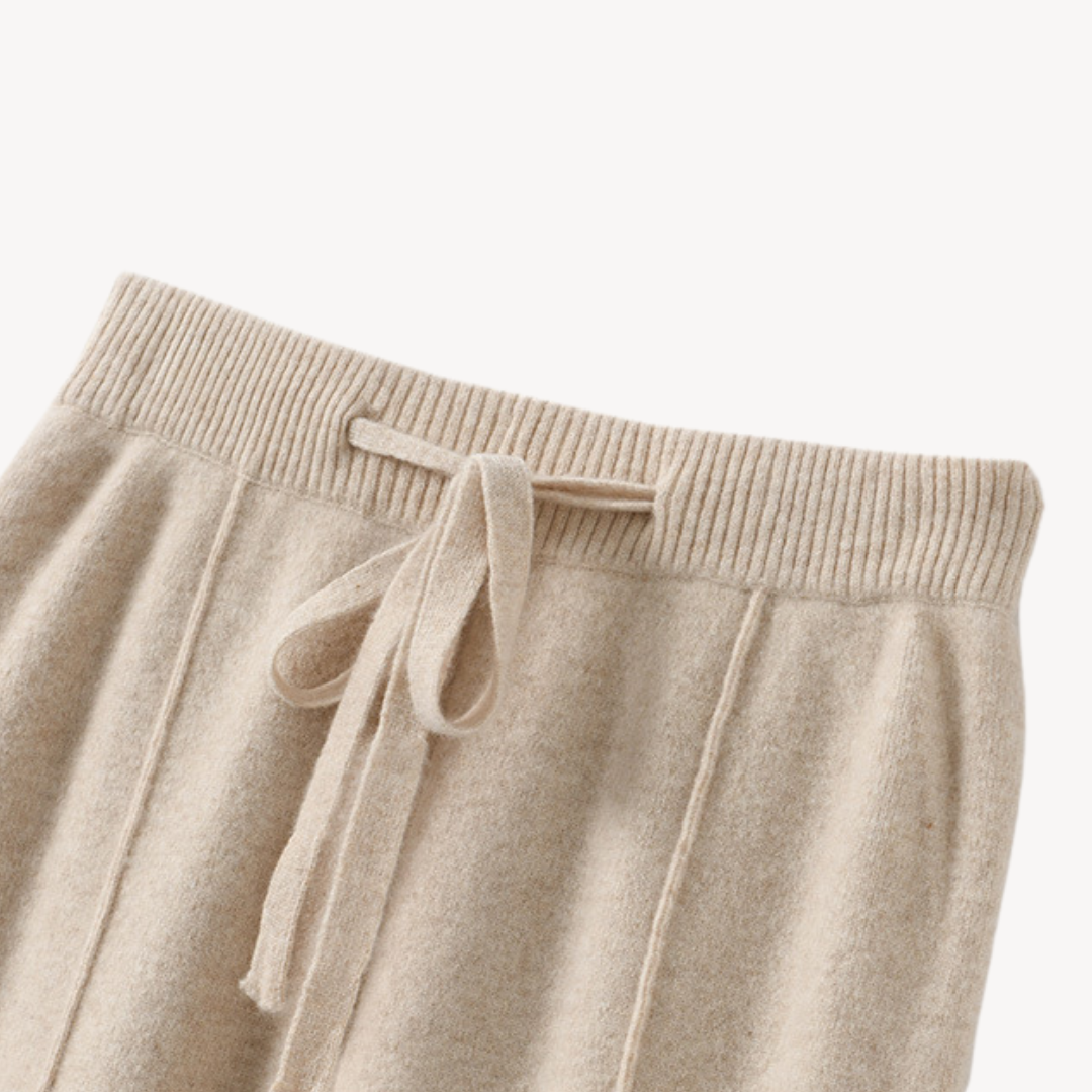 Beige cashmere wide-leg pants for women, offering comfort and style with a relaxed fit and drawstring adjustable waist.