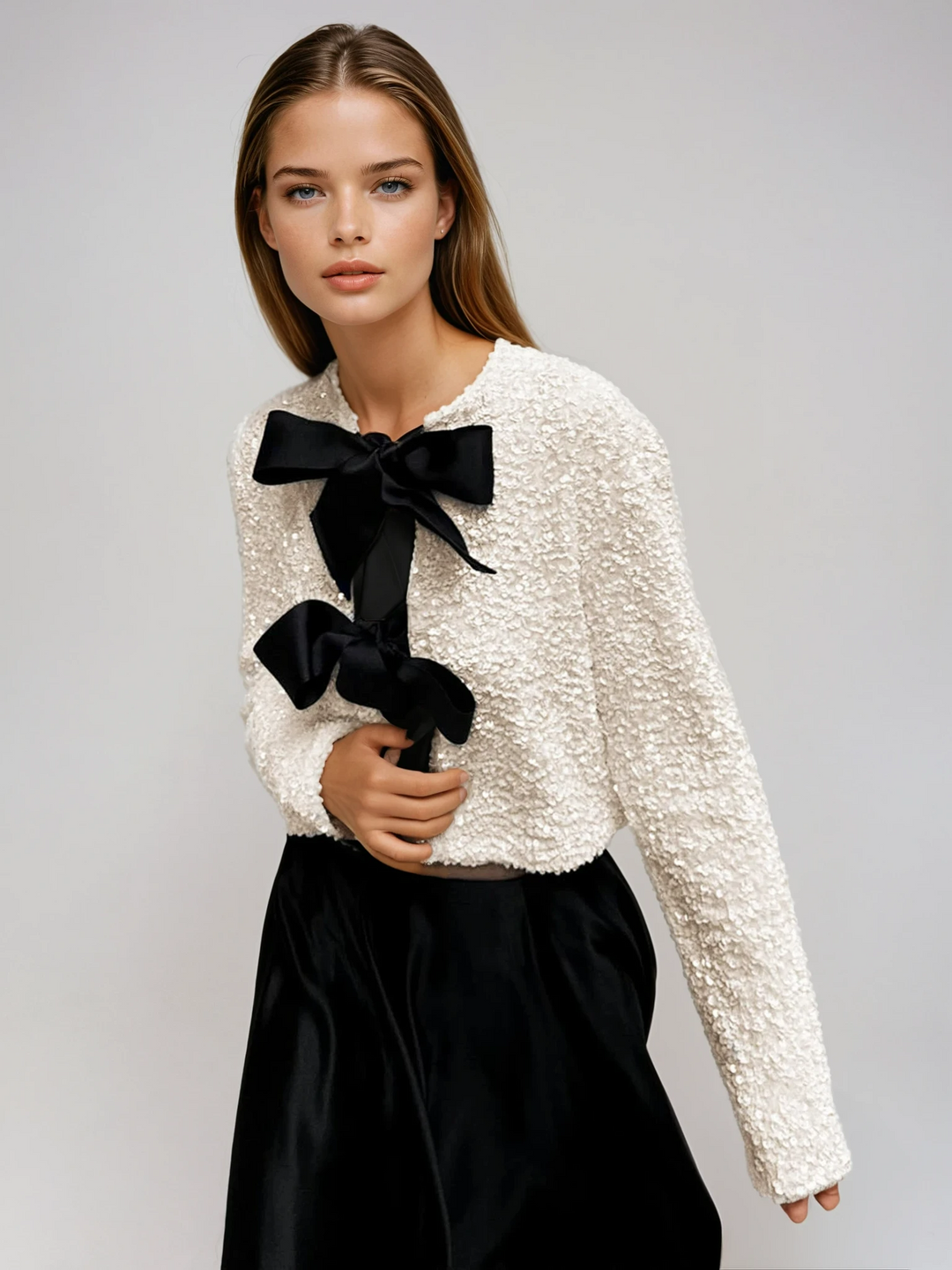 Beige sparkling textured women's jacket with an elegant bow detail, perfect for evening and special occasions.