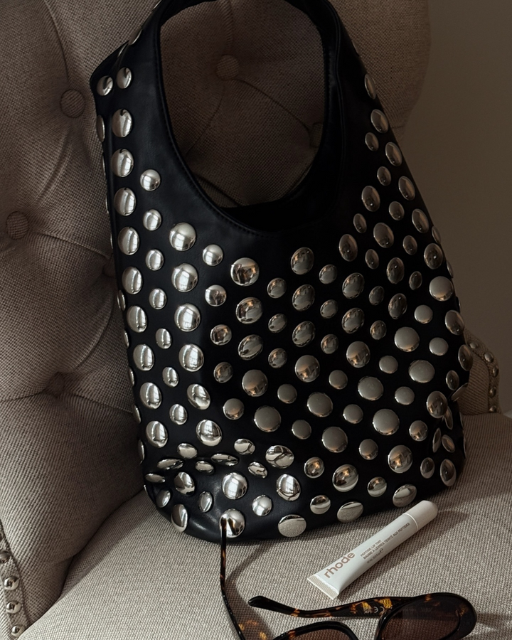 Chic black faux leather studded shoulder bag for women, featuring intricate rivet detailing and a fashion-forward look.