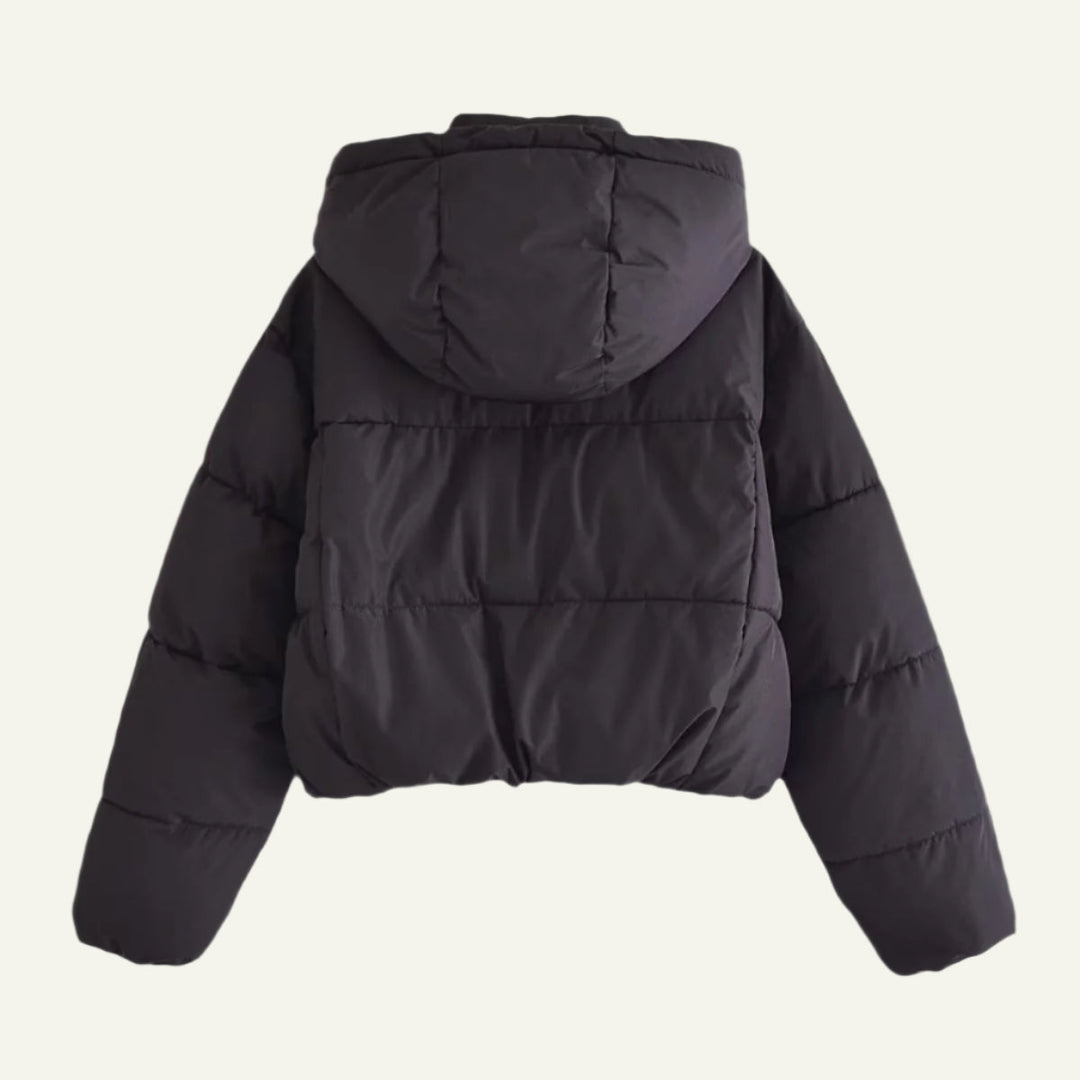 Durable black puffer jacket for women. Offers lightweight warmth and insulation for harsh winter conditions.