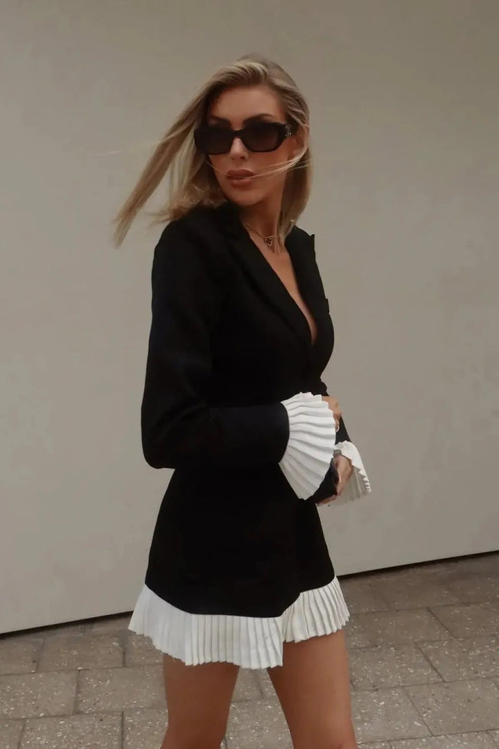 Sophisticated women's pleated mini dress in black, with a chic V-neck design and classic button front.
