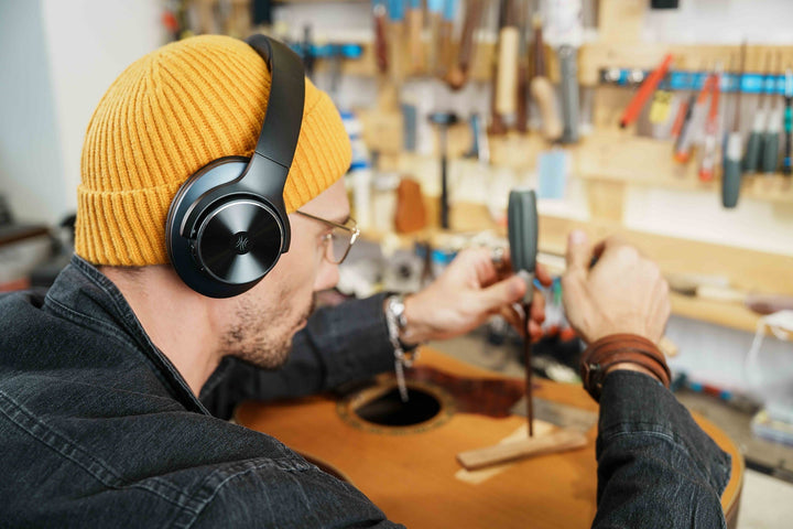 Black wireless over-ear headphones with Bluetooth and hybrid active noise cancellation, featuring memory foam earcups and USB