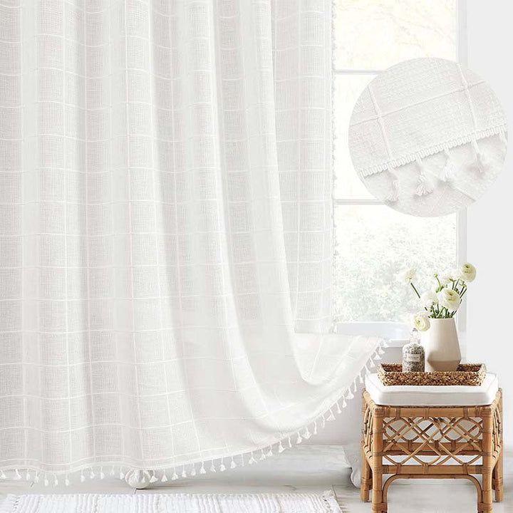 "Bohemian farmhouse waterproof linen shower curtain with decorative tassels, shown in a warm beige plaid pattern."