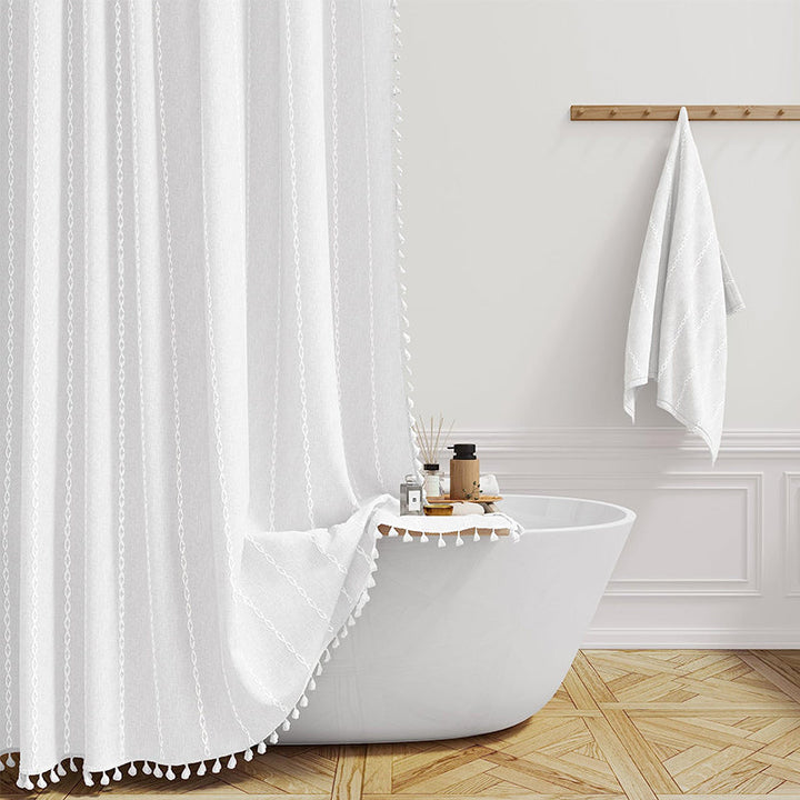 "Bohemian farmhouse waterproof linen shower curtain with decorative tassels, shown in a warm beige plaid pattern."