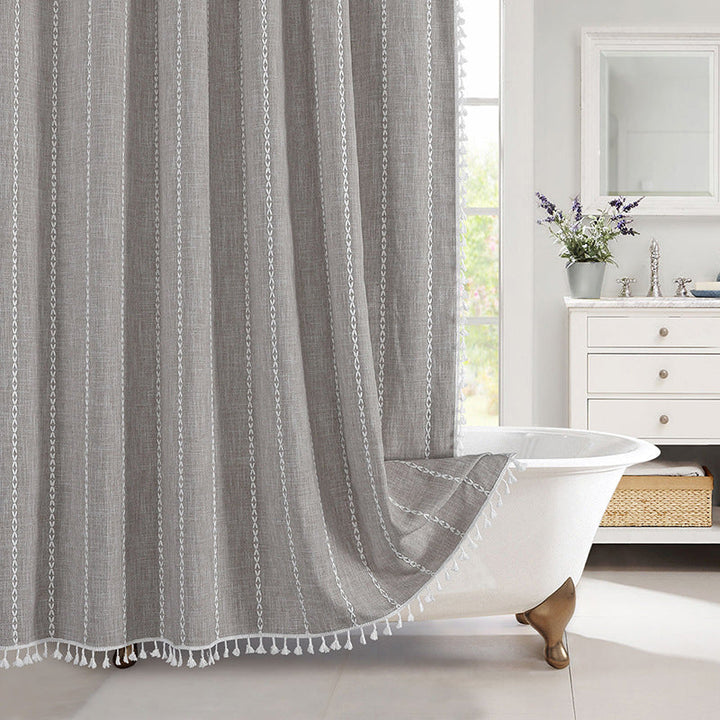 "Bohemian farmhouse waterproof linen shower curtain with decorative tassels, shown in a warm beige plaid pattern."