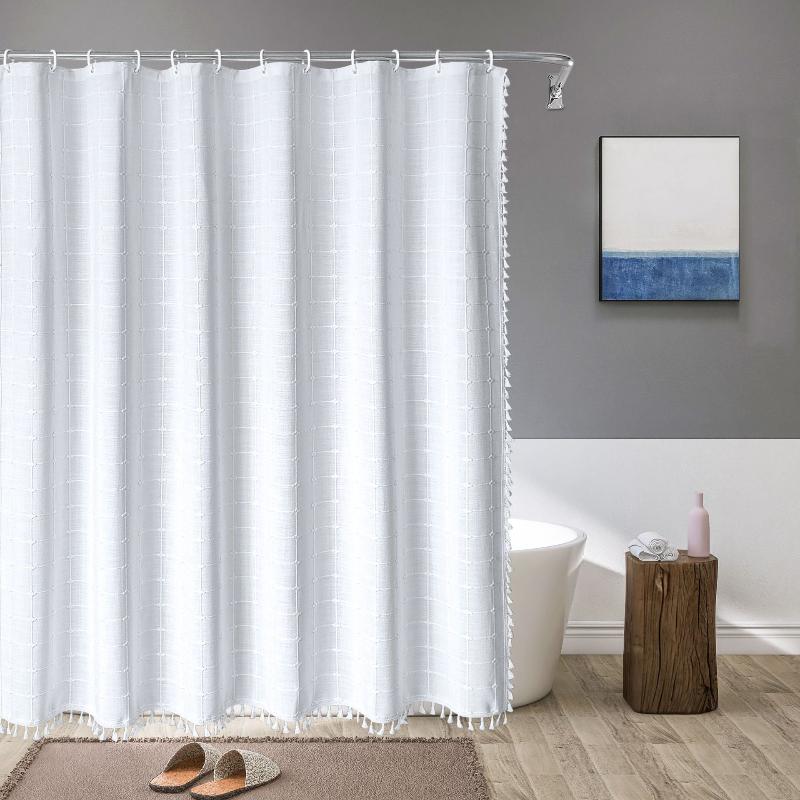 "Bohemian farmhouse waterproof linen shower curtain with decorative tassels, shown in a warm beige plaid pattern."