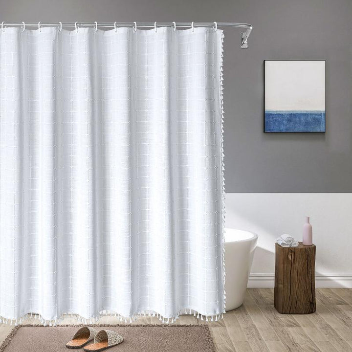"Bohemian farmhouse waterproof linen shower curtain with decorative tassels, shown in a warm beige plaid pattern."
