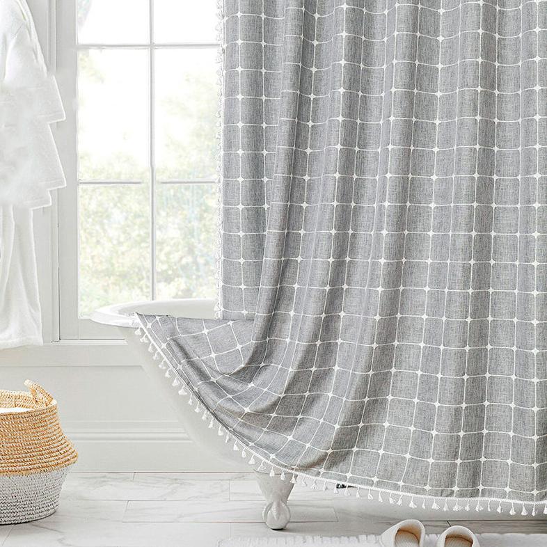 "Bohemian farmhouse waterproof linen shower curtain with decorative tassels, shown in a warm beige plaid pattern."