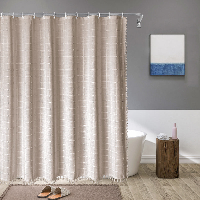 "Bohemian farmhouse waterproof linen shower curtain with decorative tassels, shown in a warm beige plaid pattern."