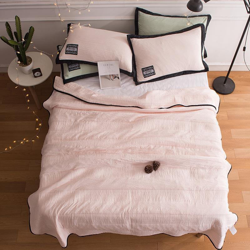 Unisex cooling blanket, a soft & breathable cotton-blend throw providing restful sleep in summer.