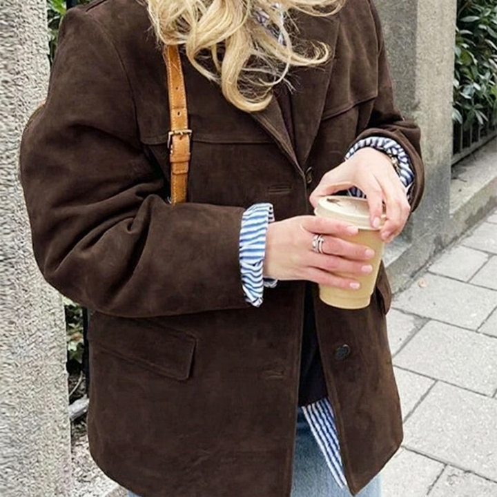 Women's oversized brown blazer featuring notched lapel, button front. Ideal for workwear or casual chic.
