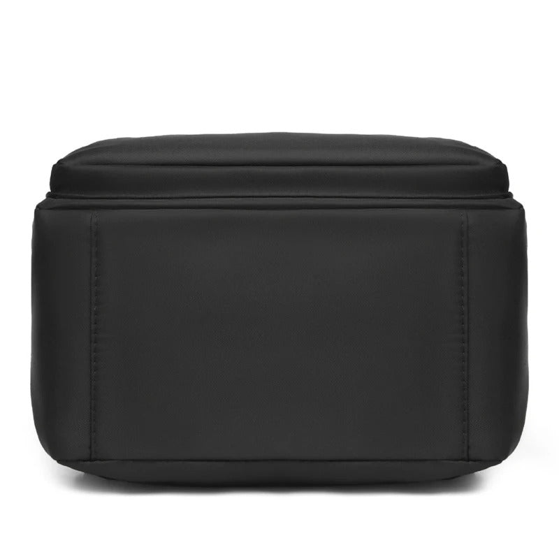 Modern women's PU leather backpack, black, offering a chic look for urban travel and school.