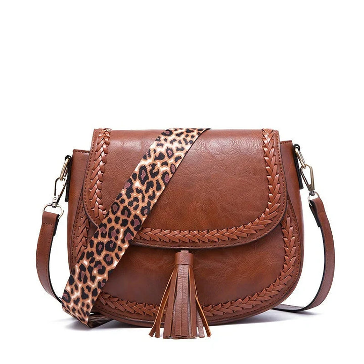 Modern women's small faux leather shoulder bag with chic tassel, suitable for daily use.