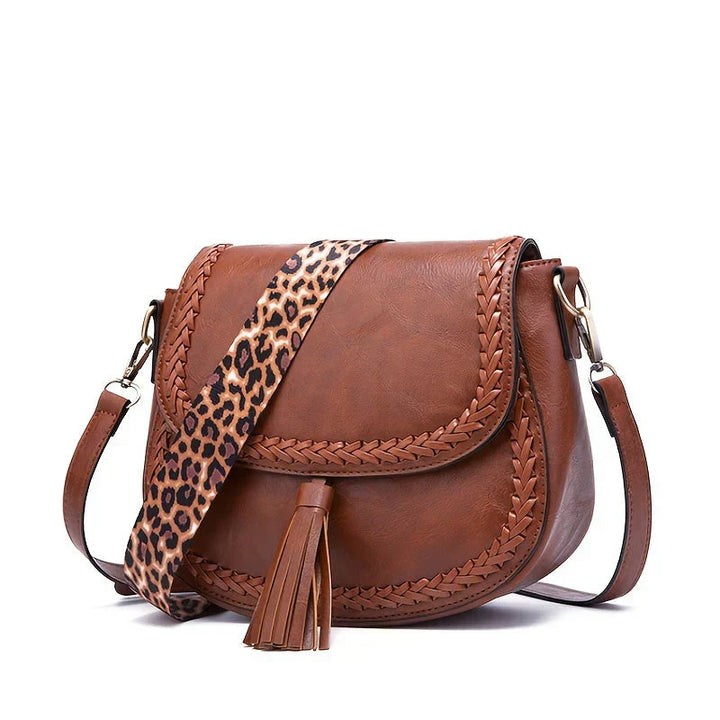 Refined women's shoulder bag, small and chic faux leather design with a delicate tassel.