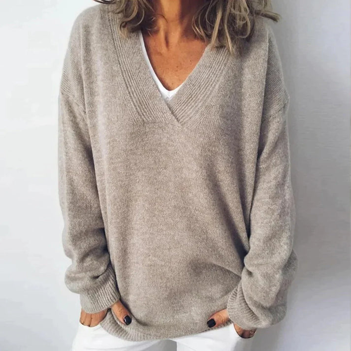 Chic women's beige cashmere V-neck knit jumper. Soft, relaxed fit for elegant everyday comfort and layering.