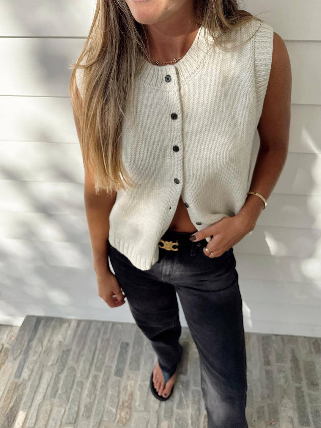 Women's button-front sweater vest in a stylish apricot knit, designed for versatile layering and chic looks.