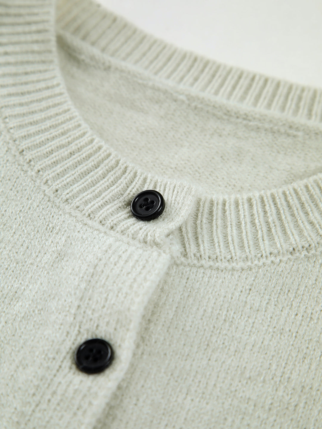 Fashionable women's sleeveless sweater vest in light grey, excellent for transitional weather layering.