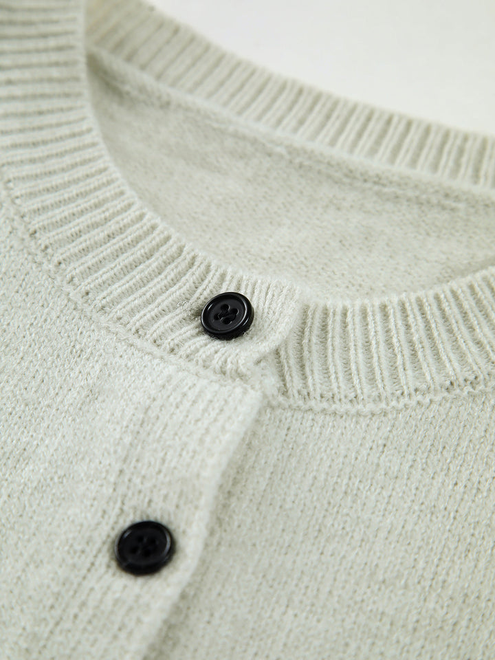 Fashionable women's sleeveless sweater vest in light grey, excellent for transitional weather layering.
