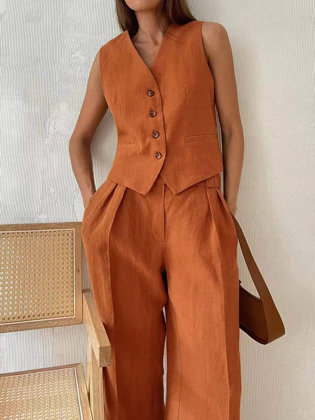 Elegant women's summer outfit: cotton linen waistcoat and wide-leg trousers set. Ideal for resort or casual chic.