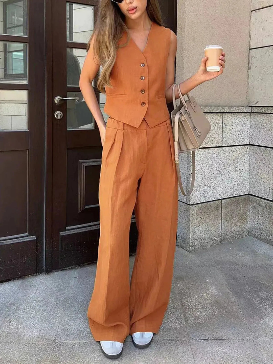 Breathable women's linen blend two-piece set. Includes a stylish waistcoat and comfortable wide-leg trousers.
