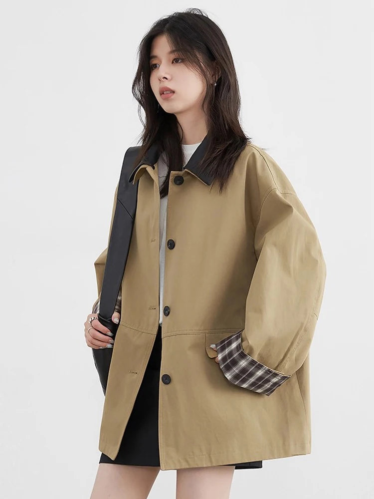 Women's dark beige button-up jacket with sophisticated contrast trim and plaid details, suitable for winter fashion.