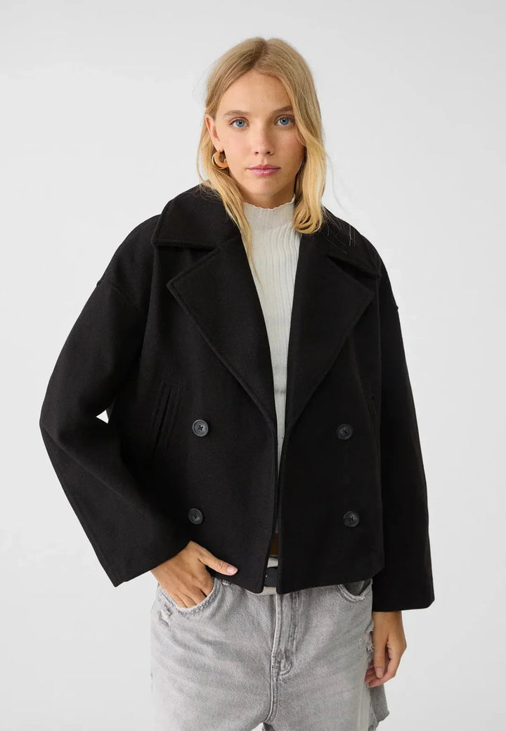 Elegant women's tailored cropped jacket, double-breasted for chic modern fashion.