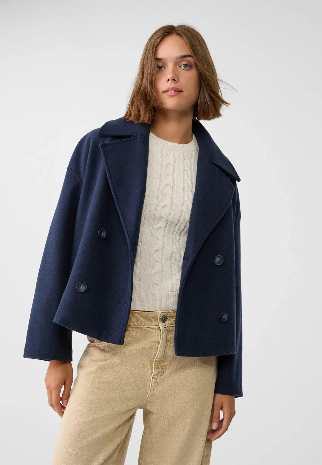 Stylish women's double-breasted short jacket, a modern tailored coat for elegant outerwear.