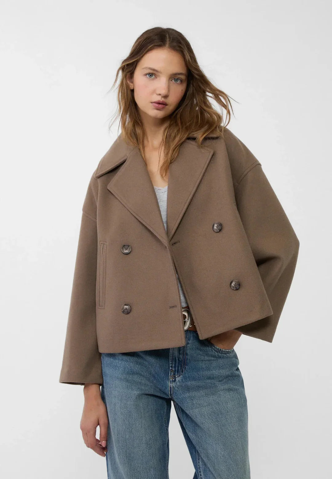 Cropped double-breasted women's jacket, chic and tailored for a modern fashion short coat.