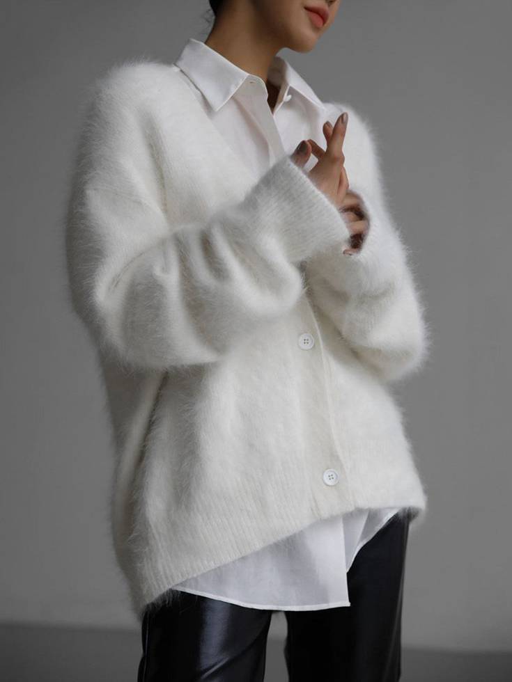 Stylish women's oversized button-up long sleeve cardigan. A modern layering top for chic casual and relaxed everyday fashion.