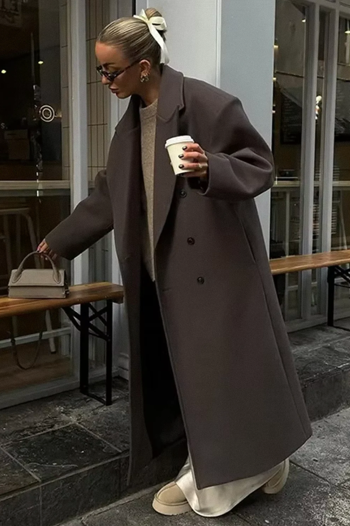 Chic women's oversized double-breasted long coat. Elegant winter outerwear for sophisticated layering.