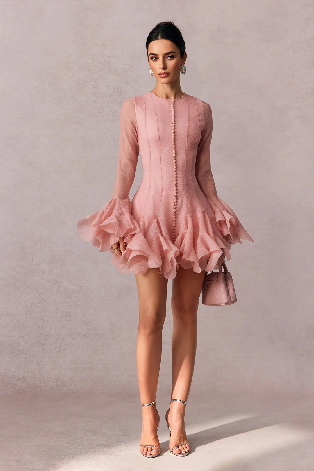 Stylish women's pink long sleeve mini ruffle dress. A chic and modern cocktail or party dress.