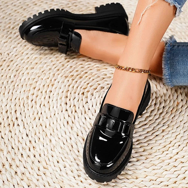Fashionable women's slip-on platform loafers with bow detail, combining modern style and easy wear.