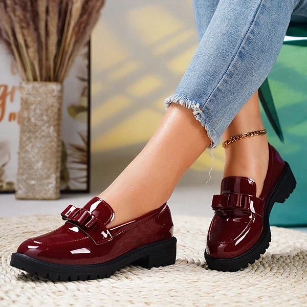 Red women's platform loafers, a bold slip-on choice with elegant bow detail for fashion-forward style.