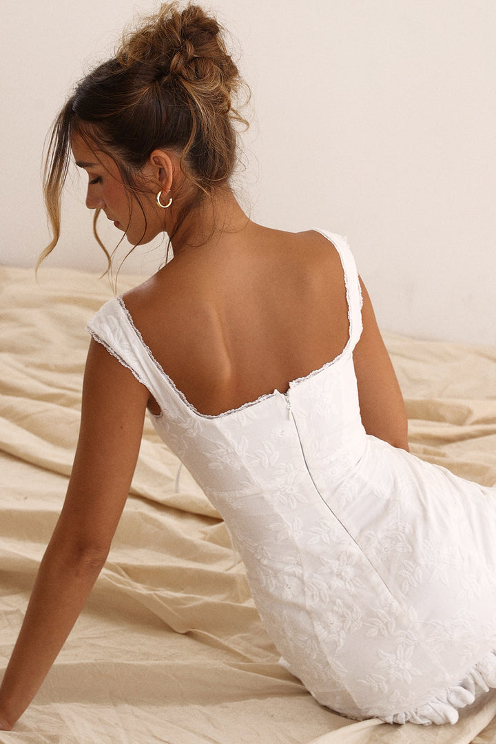 Elegant women's white mini dress with a flattering tie-waist design, perfect for summer fashion & party style.