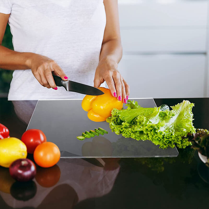 Modern clear non-slip acrylic cutting board for a sleek kitchen. Perfect for hygienic food prep and serving.