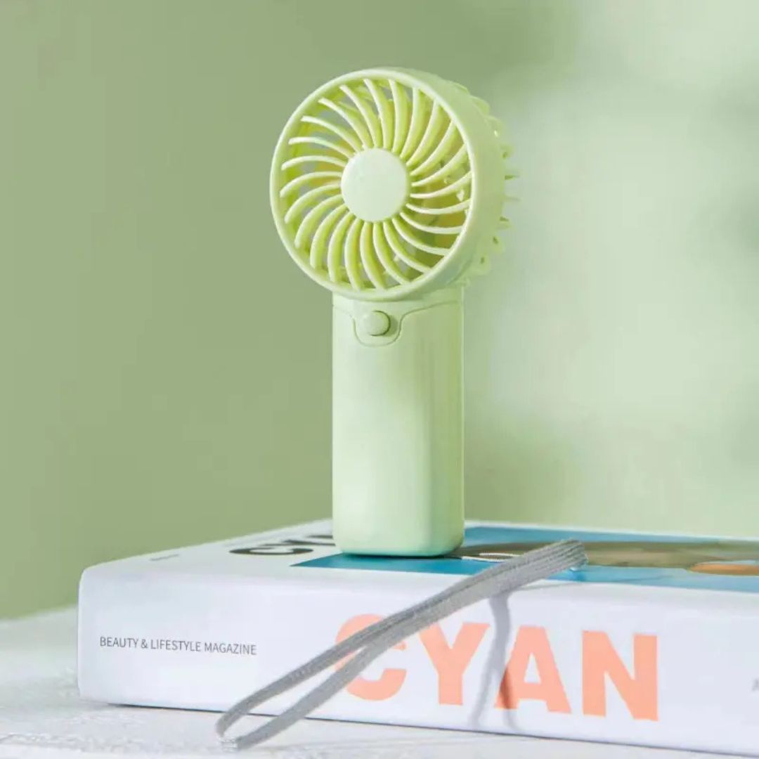 "Compact portable mini fan, sleek design in white, pocket-sized cooler for travel or office, beauty wellbeing essential."