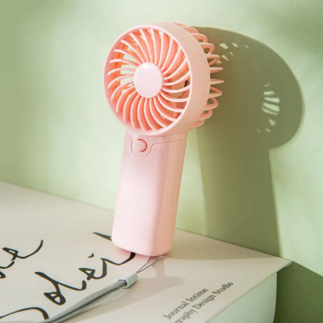 "Compact portable mini fan, sleek design in white, pocket-sized cooler for travel or office, beauty wellbeing essential."