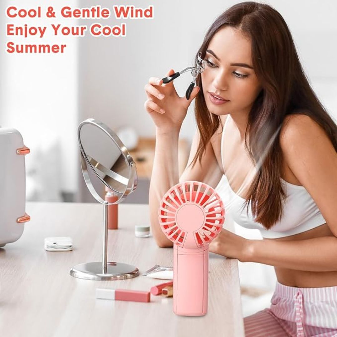 "Compact portable mini fan, sleek design in white, pocket-sized cooler for travel or office, beauty wellbeing essential."