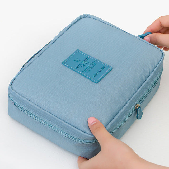 Durable waterproof makeup organizer travel bag for women, compact & secure.