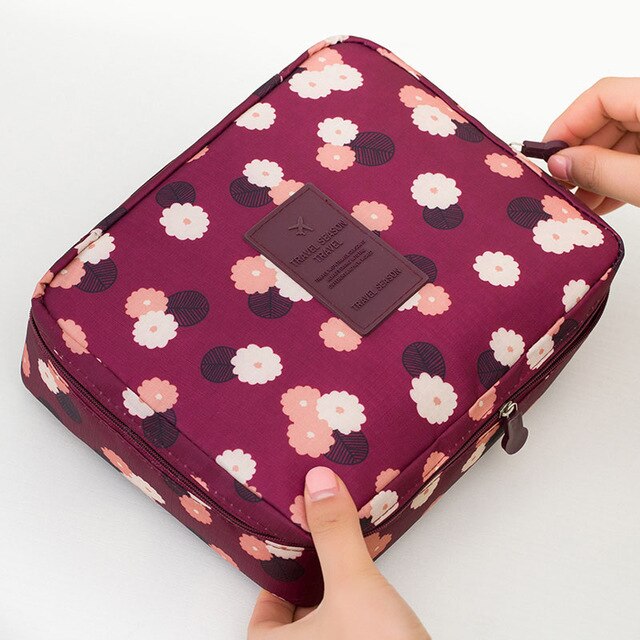 Compact waterproof travel organizer for women's makeup and beauty supplies.